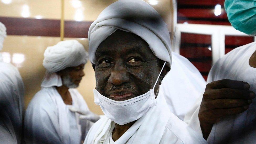 Sudan's former vice president Ali Osman Taha is pictured behind the bars during the trial of ousted president Omar al-Bashir