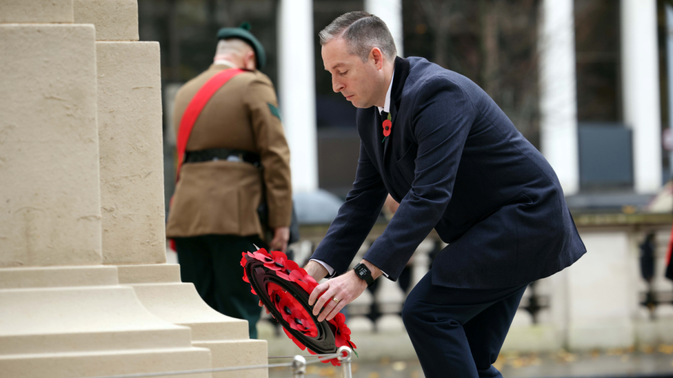 First Minister Paul Givan lays a wreath at the cenotaph in Belfast