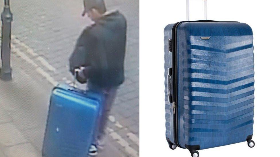 Abedi with a blue suitcase