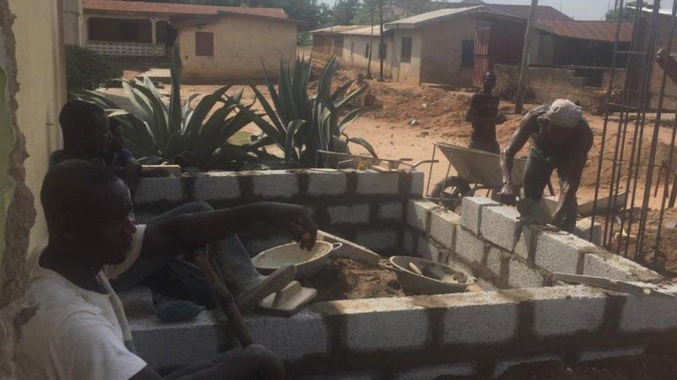 Construct workers building a wall in Ghana