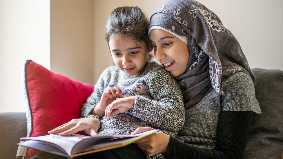 two-sisters-reading-together