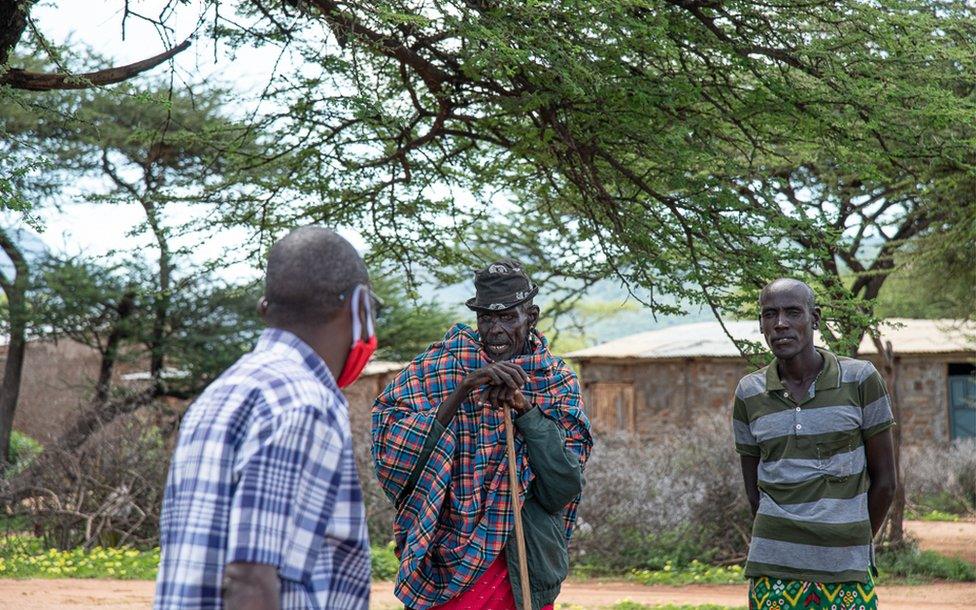 The helicopter crew stop to speak with communities