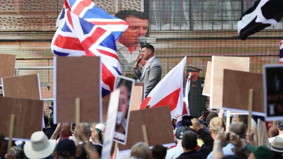 Tommy Robinson greets his followers outside the Old Bailey in July 2019