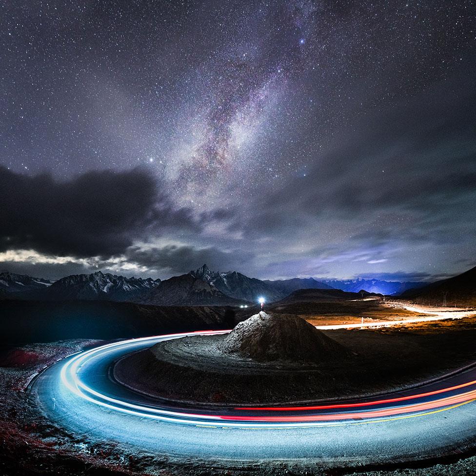 An image of the night sky and a long exposure shot of a car driving around a mound of rock