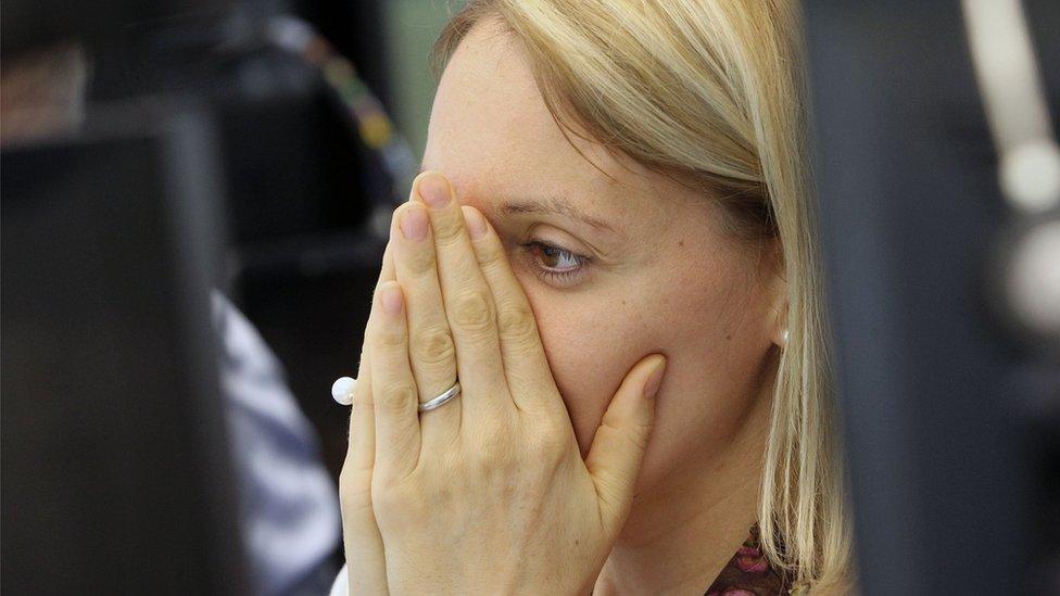 A broker reacts at the German stock exchange in Frankfurt, Germany