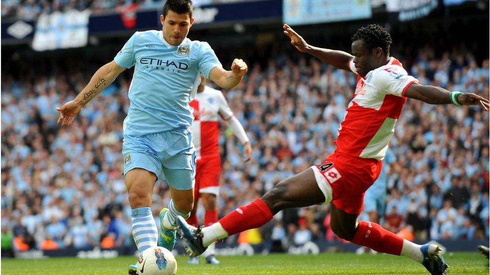 Manchester City's Sergio Aguero goes round Queens Park Rangers' Taye Taiwo to score the winning goall.