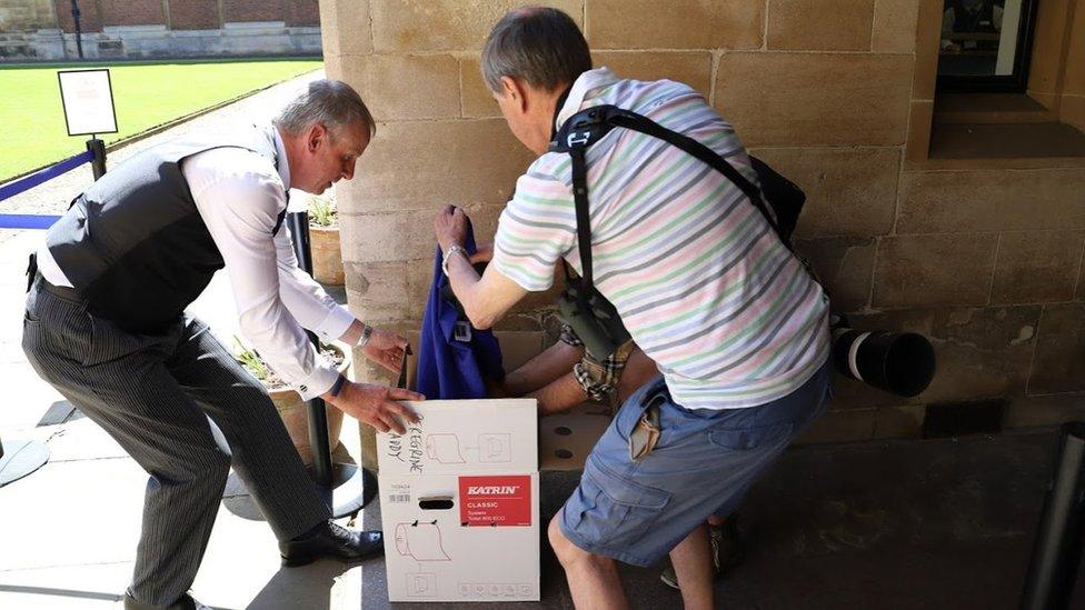 Peregrine being put in a box