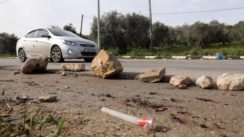 Palestinians check the area where three militants were killed, near the village of Araba, in the occupied West Bank (2 April 2022)