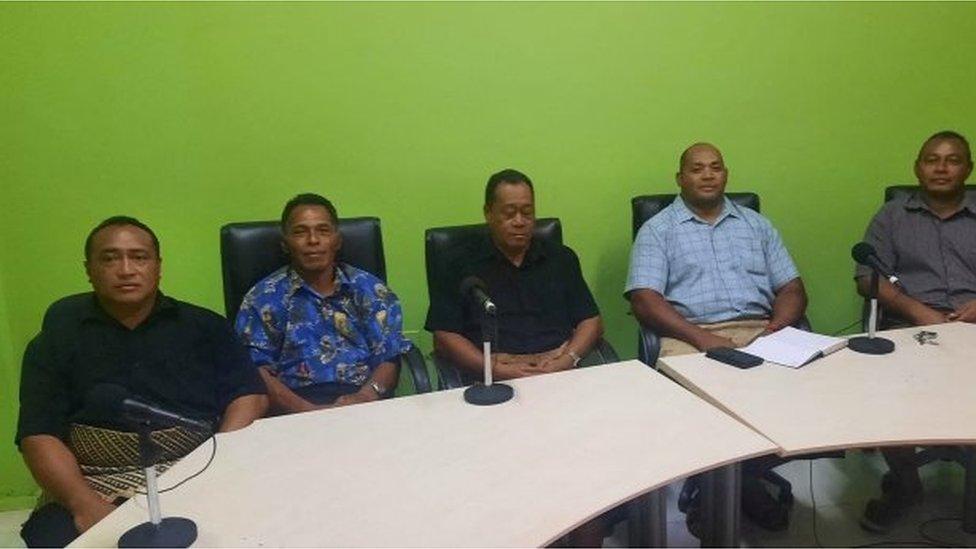 Lisala Folau (second from left) sits with other Atata survivors in a room at a radio station