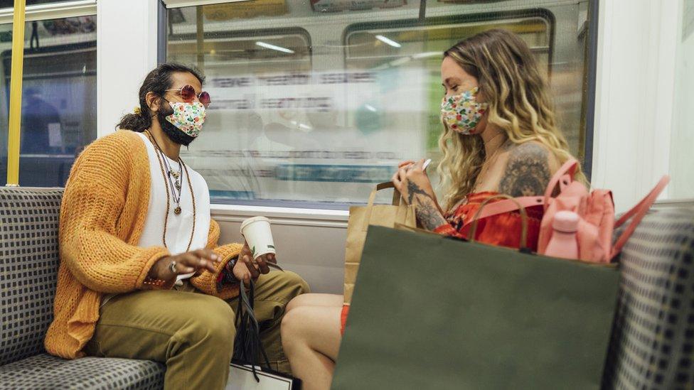 Man and woman wear masks on Metro