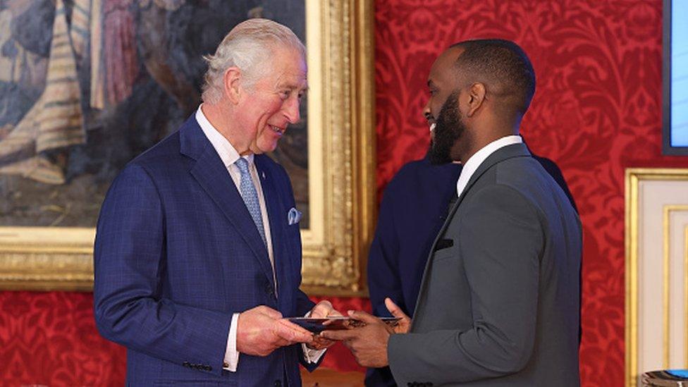 Prince Charles, when Prince of Wales, presenting The Watches of Switzerland Group Young Change Maker award to Cordell Jeffers during the Prince's Trust Awards Trophy Ceremony at St James's Palace