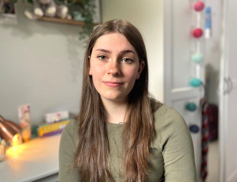 Ailsa Law sits at her desk in her room