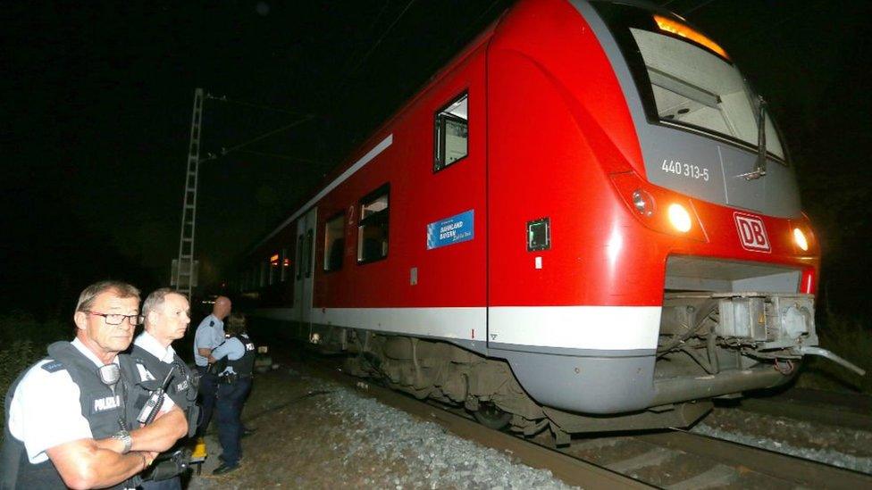 Police stand by regional train on which man wielding axe attacked passengers in Wuerzburg, Germany, 18 July 2016