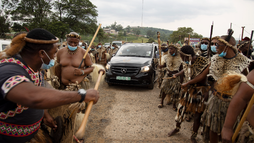 Zulu guard of honour for car carrying the king's body in Nongoma, South Africa - 17 March 2021