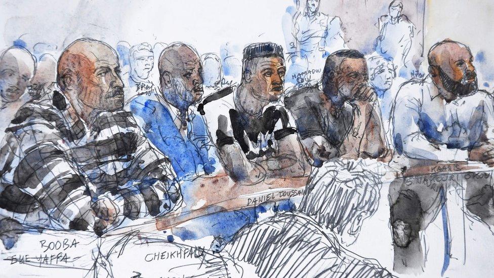 This court sketch made on September 6, 2018, shows French rappers Booba (L) and Kaaris (R) sitting with other defendants in a courtroom at the courthouse of Creteil, near Paris