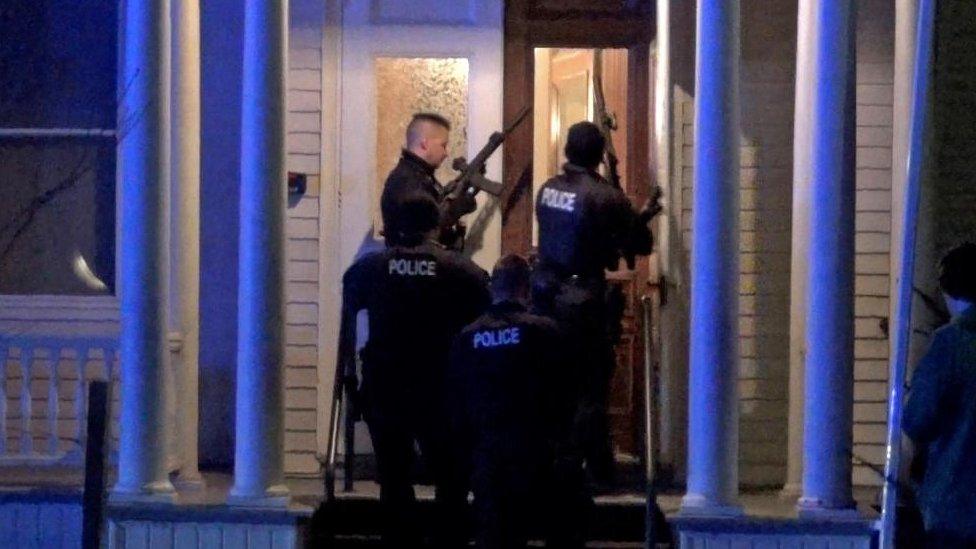 Police search a house in the neighbourhood