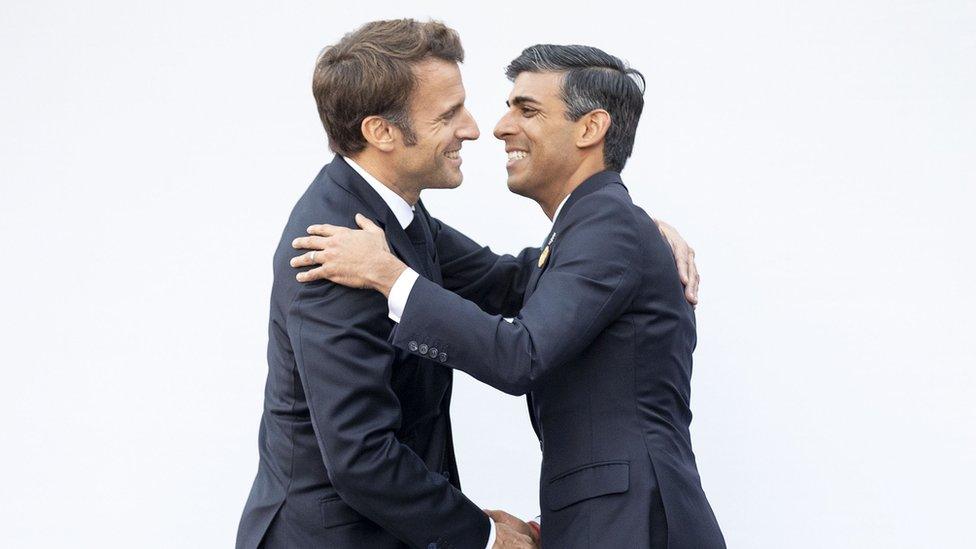 French President Emmanuel Macron and British Prime Minister Rishi Sunak embrace at the Cop27 summit in Egypt