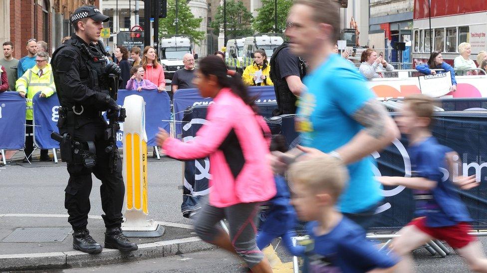 Armed officer overseeing the race