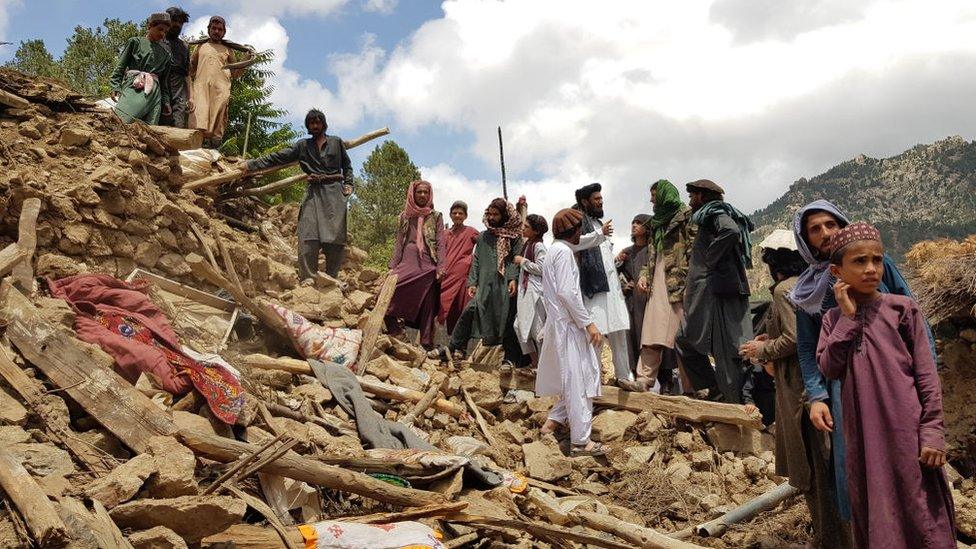 People help for the search and rescue operations on debris of a building after a magnitude 7.0 earthquake shook Afghanistan at noon and killed at least 29 people, and injured 62 others in the Spera district of Khost province near Paktika province, Afghanistan on June 22, 2022.