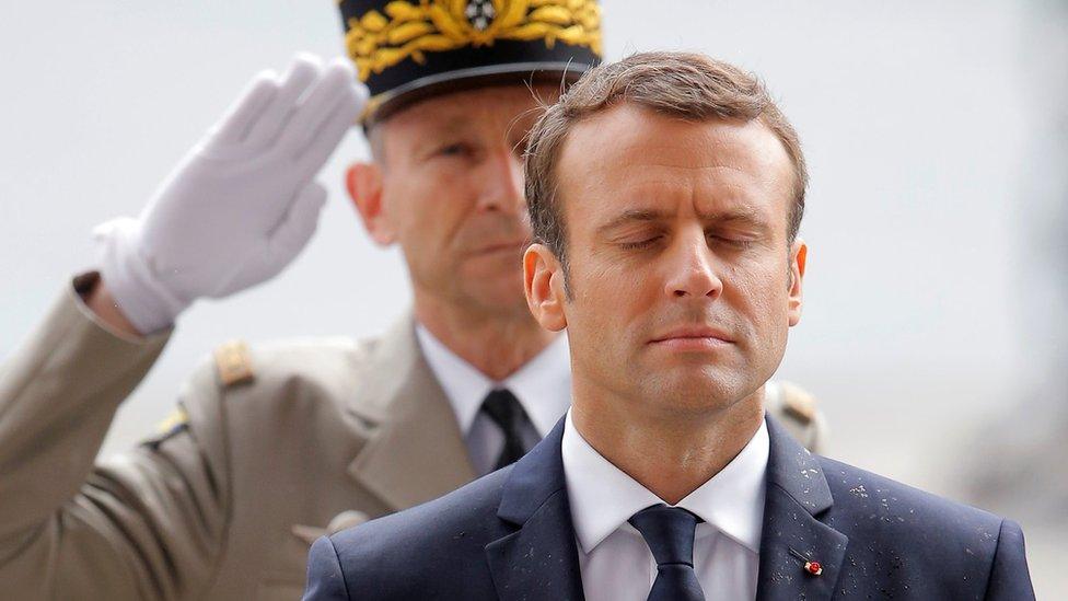 Emmanuel Macron observes a minute of silence during a wreath laying ceremony at the Arc de Triomphe in Paris on May 14, 2017