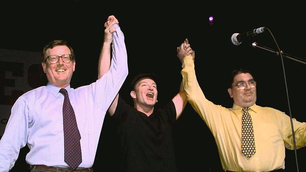 U2 frontman Bono posing with UUP leader David Trimble and SDLP leader John Hume at a concert calling for a Yes vote in the referendum on the Good Friday Agreement