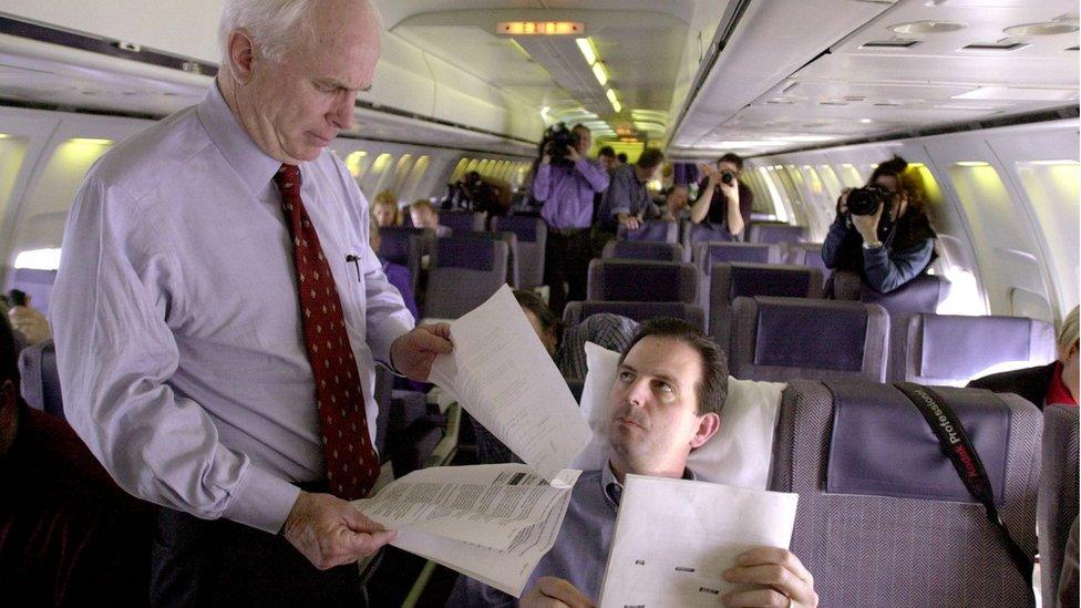 Late Senator John McCain looks over documents with campaign adviser John Weaver in 2000