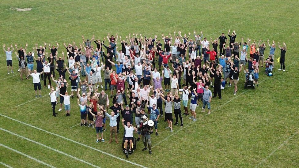 Men raising their hands to say having a mental health issue is OK