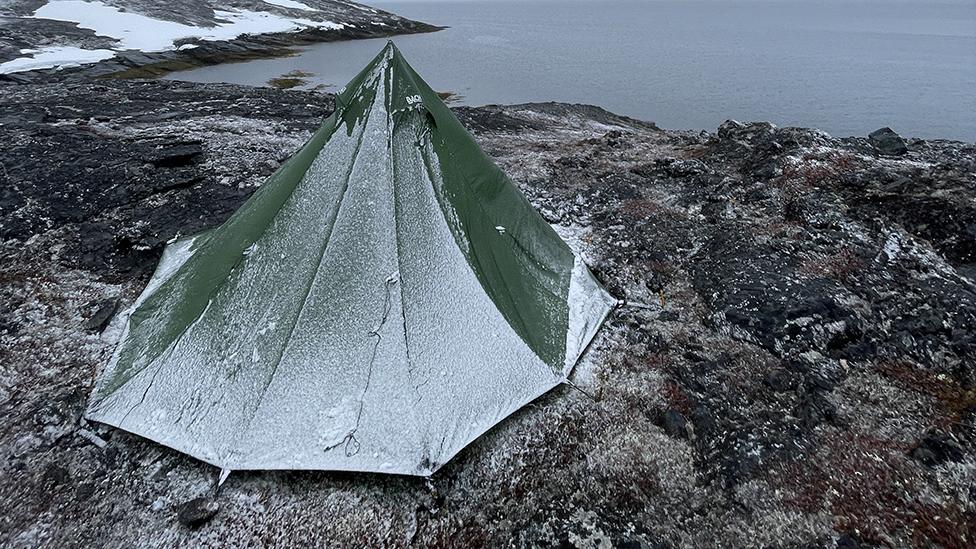 Mike Keen's tent covered in ice near the water in Greenland