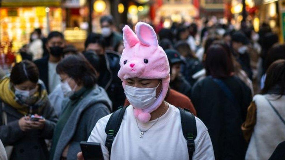 People walk down a street in the Chinatown section of Yokohama.