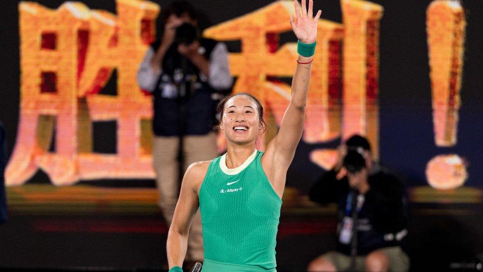 Zheng Qinwen waves to the crowd after her semi-final victory on 25 January at the Australian Open