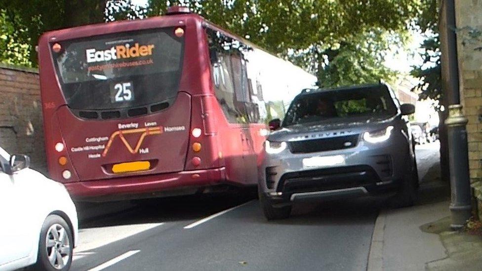 Car mounting the kerb