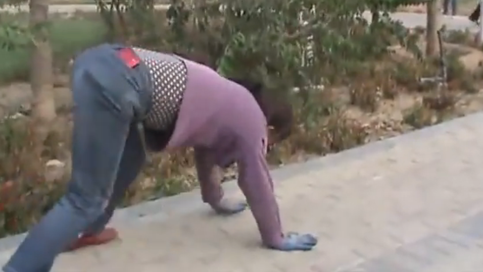 A woman crawling on the ground