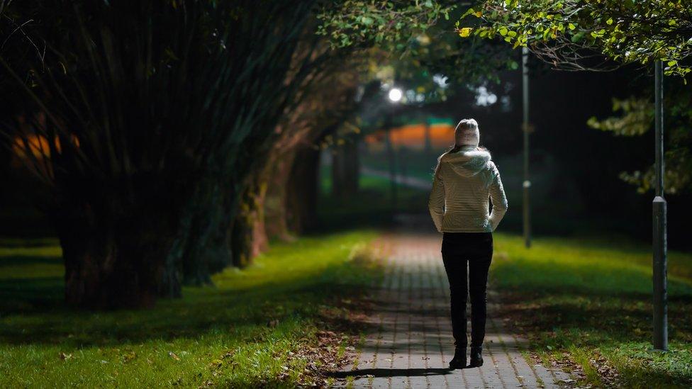 Woman walking through park