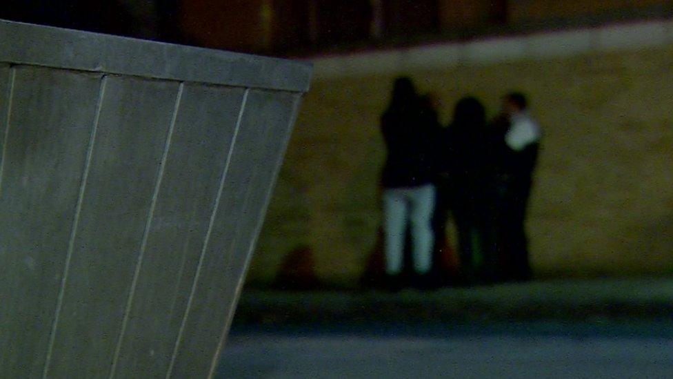 Mental health workers talking to a man on an east London street