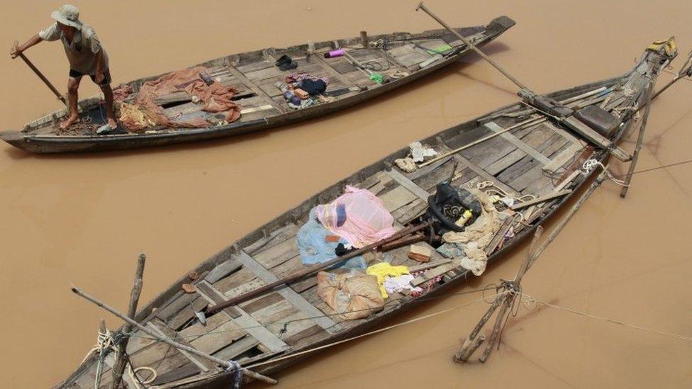 A Cambodian fisherman rows his boat on the Mekong River in Phnom Penh, Cambodia, on 22 September 2015