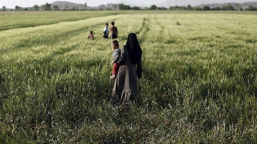 A Syrian refugee with her children in Greece