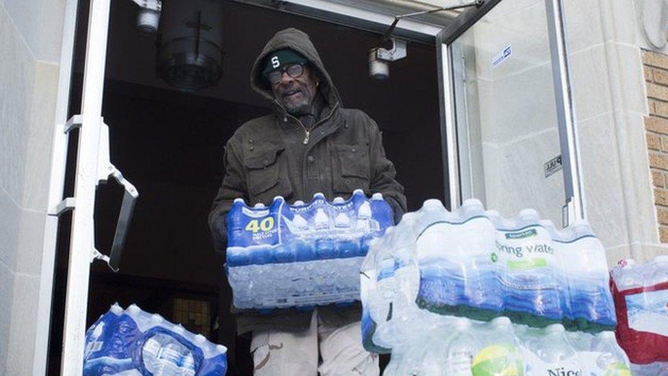 Man stacking water