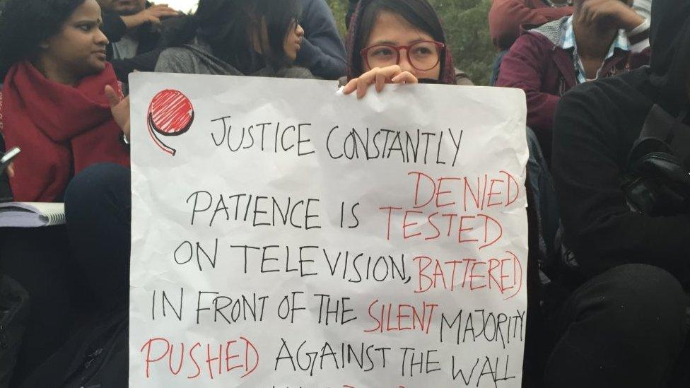 A student holding a placard at the JNU campus