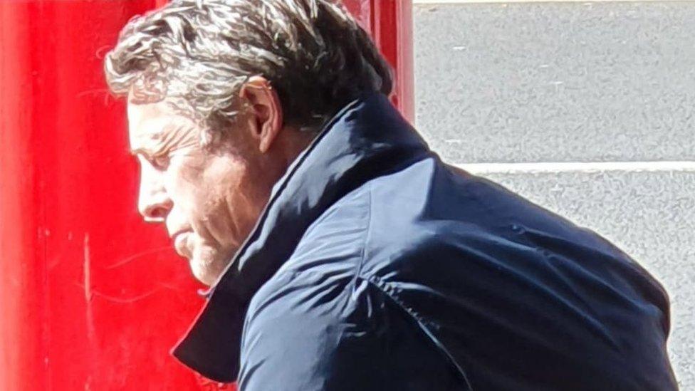 Hugh Grant outside bakery