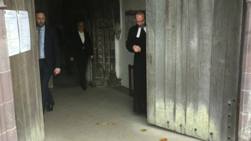 Cathedral staff close the doors ready for the electoral college to begin