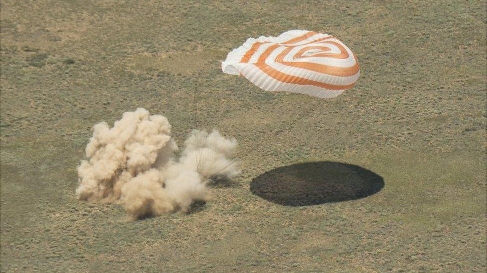 The Soyuz capsule as it hits the ground in Kazakhstan