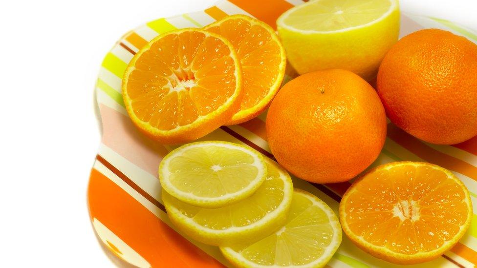 A plate of oranges and lemons