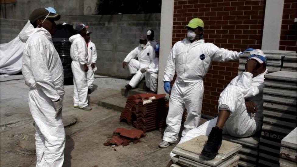 Forensic workers rest outside a morgue in Santa Catarina Pinula, on 5 October, 2015.