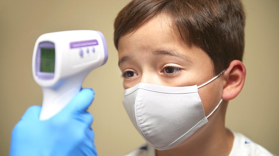 Child having temperature taken