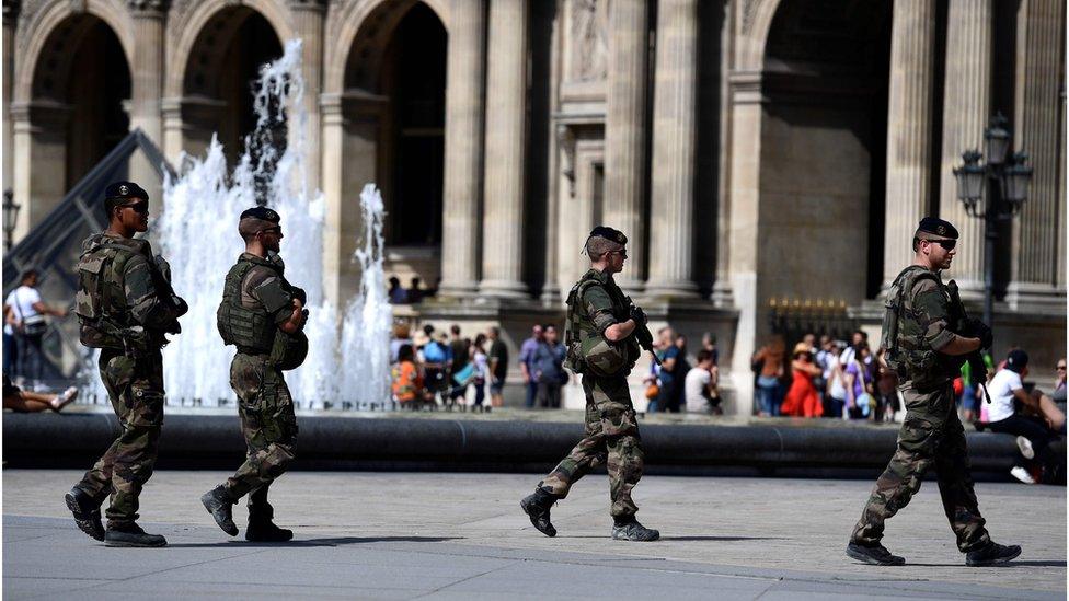 Soldiers patrol around the Louvre Museum in Paris on 10 September 2016.