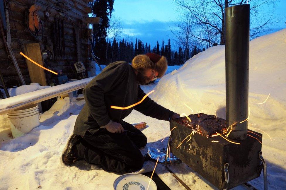 David lights a fire outside