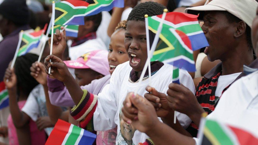 Children at Nelson Mandela's funeral sing Nkosi Sikelel' iAfrika and wave flags