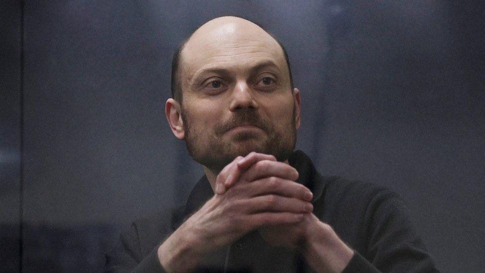 Jailed Russian opposition figure Vladimir Kara-Murza gestures as he stands behind a glass wall of an enclosure for defendants during a court hearing to consider an appeal against his prison sentence, in Moscow, Russia July 31, 2023.