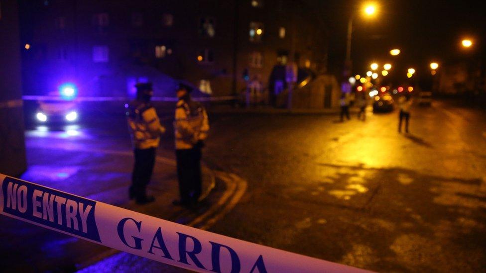 Irish police officers attend the scene on Poplar Row, following the shooting of a man in Dublin