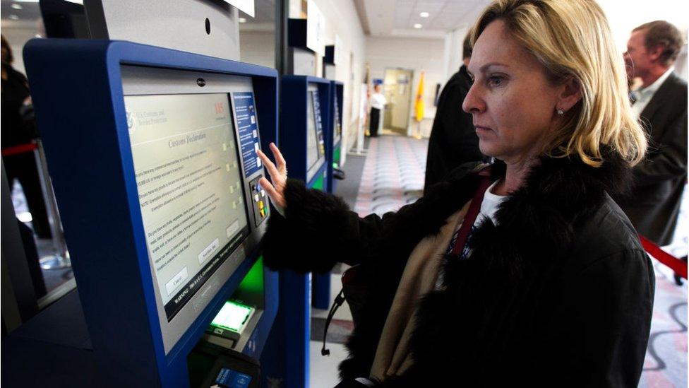 Woman using global entry system